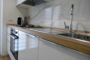 a kitchen with a sink and a counter top at My Home Saronno in Saronno