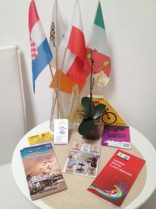 a table with books and flags on it at Hostel Gdańsk Sun and Sea in Gdańsk