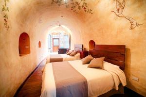 A bed or beds in a room at Hacienda Las Cuevas Terra Lodge