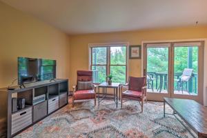 a living room with a television and a table and chairs at Lake Placid Retreat Less Than 1 Mi to Mirror Lake Beach! in Lake Placid