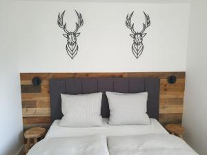 a bedroom with a bed with two deer head decals at WALDVILLA Bad Kleinkirchheim in Bad Kleinkirchheim