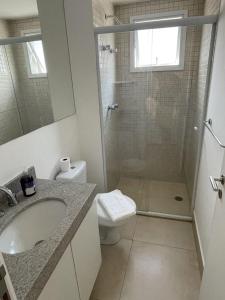 a bathroom with a shower and a sink and a toilet at Lindo Studio no coracao da Vila Madalena in Sao Paulo