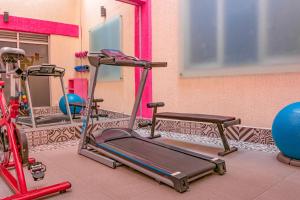 a gym with two tread machines and a bike at Ayenda Frida Costa Azul in Mexico City