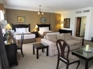 een hotelkamer met 2 bedden en een bank bij Best Western Hotel Posada Del Rio Express in Torreón