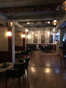 a dining room with tables and chairs and lights at Hotel Royal in Tetovo