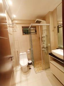 a bathroom with a shower and a toilet and a sink at Premium Flat Praia Calma in Natal