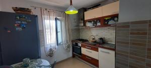 a kitchen with a sink and a stove top oven at Serghi in Mangalia