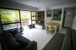 a living room with a couch and a table at Apê Namastê in Rio de Janeiro