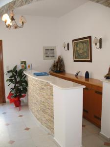 a kitchen with a counter in a room at Aegeon Hotel in Naxos Chora