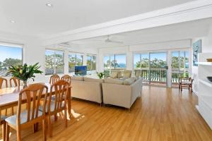 a living room with a couch and a table at Noosa Escape 2Br Allambi Rise in Noosa Heads