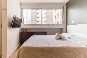Cama o camas de una habitación en Studio moderno, novo, completo próximo Av Paulista