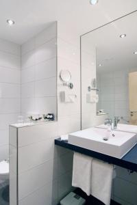 a bathroom with a sink, toilet and shower at Holiday Inn Prague Airport, an IHG Hotel in Prague