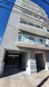 a building with a parking garage in front of it at Bella Vista in Cipolletti