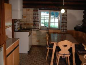 a kitchen with a table and chairs in a room at Ferienhaus Vollspora in Schruns