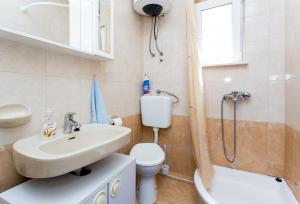 a bathroom with a sink and a toilet and a shower at Apartmani Kate, Plat in Mlini