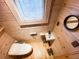 a bathroom with a white sink and a mirror at BAAN HAKUBA in Hakuba