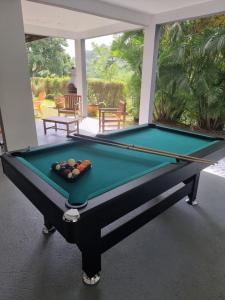 a pool table with balls on top of it at Le Goyav' appart avec piscine et jacuzzi au Vauclin in Le Vauclin