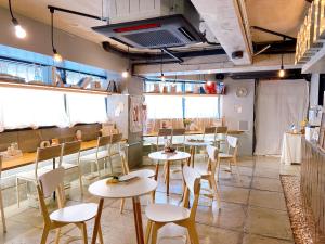 a restaurant with tables and chairs in a room at Book Tea Bed SHINJUKU-GYOEN in Tokyo