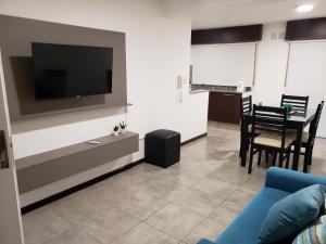 a living room with a blue couch and a tv at Costanera.VM in Villa María