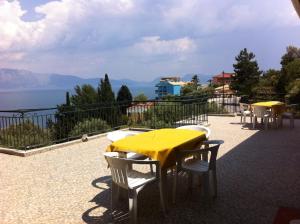 a yellow table and chairs on a patio with a view at Georgia in Nikiana