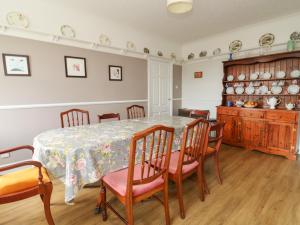 uma sala de jantar com mesa e cadeiras em Woodhill em Bentley