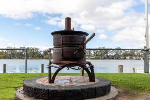 a statue of a stove sitting next to a body of water at 14 Randell Street, Mannum in Mannum