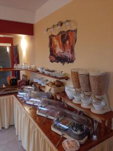 a buffet with food on a table in a kitchen at Hotel Prox in Arnstadt