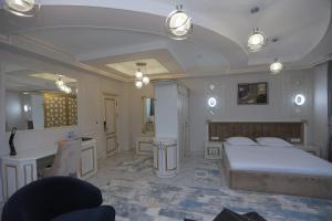 a bedroom with a bed and a sink and a mirror at Reikartz Amirun Tashkent in Tashkent
