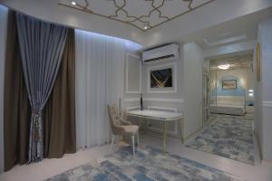 a hospital room with a desk and a bed at Reikartz Amirun Tashkent in Tashkent
