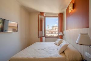 a hotel room with a bed and a window at Hotel della Signoria in Florence