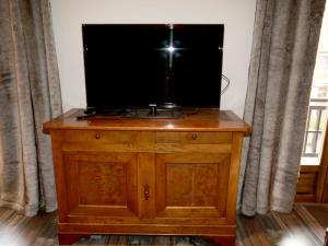 telewizor na drewnianym komodzie w obiekcie Appartement Valloire, 4 pièces, 9 personnes - FR-1-263-216 w mieście Valloire