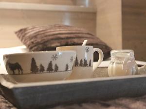 a tray with two coffee cups on a table at Appartement Valloire, 4 pièces, 9 personnes - FR-1-263-216 in Valloire
