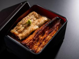 a black container with some food in it at ART HOTEL Miyazaki Sky Tower in Miyazaki