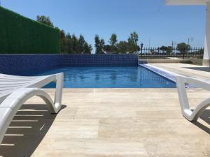 a swimming pool with a white bench next to it at SORAL APART in Demre