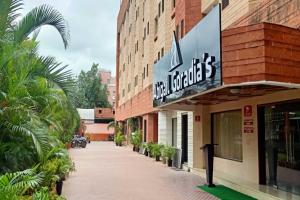 a building with a sign on the side of it at Hotel Abigail Goradia's in Shirdi