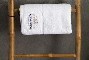 a towel on top of a wooden chair at Estate Spa - Boutique Hotel in Rechovot