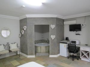 a room with a kitchen with a tub and a microwave at Olden Rose Place in Lephalale