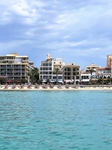 a view of a beach with buildings and the water at Hotel Marina Playa De Palma in El Arenal