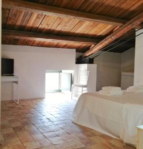 a bedroom with a bed in a room with wooden ceilings at Landolina Palace Hotel in Noto