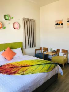 a bedroom with a bed with a colorful blanket on it at Ba Ba Xiao Wu 2 in Jinning