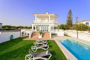 a villa with a swimming pool and a house at Genteel Home Mirador de La Barrosa in Chiclana de la Frontera