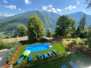 an overhead view of a swimming pool with chairs and mountains at Le Terrazze sul Lago - Ledro House in Pieve Di Ledro