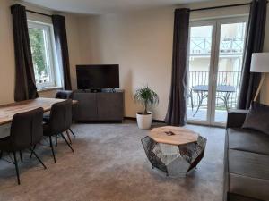 a living room with a couch and a table at Villa Weisse Düne in Göhren