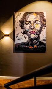 a painting of a woman on a wall at Romantik Hotel Walhalla in Osnabrück
