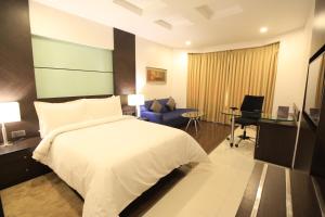 a hotel room with a bed and a desk at The Residency, Chennai in Chennai