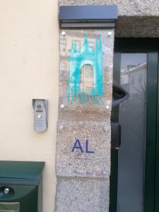 a sign on the side of a door with an al sign at Historic House in Braga