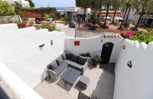 a patio with a couch and chairs on a building at Casa el Cielo Spainsunrentals 1184 in El Molino