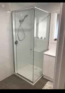 a shower with a glass door in a bathroom at Beach House Getaway 1 in Smiths Beach