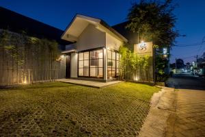 a house with a sign on the side of a street at PANDAWA VILLAS SEMINYAK in Seminyak