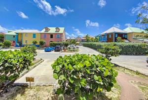 a row of houses on a street with a parking lot at Villa Casalilo, Orient Bay in Orient Bay